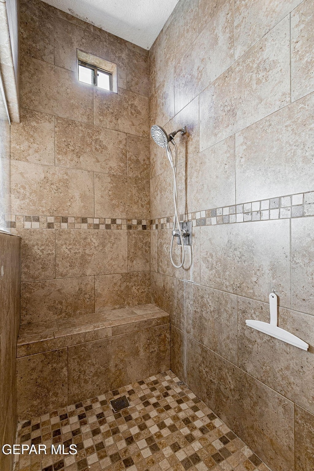 bathroom featuring a tile shower