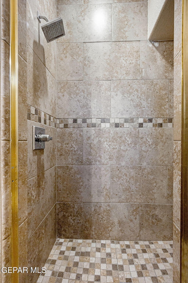 bathroom with a tile shower