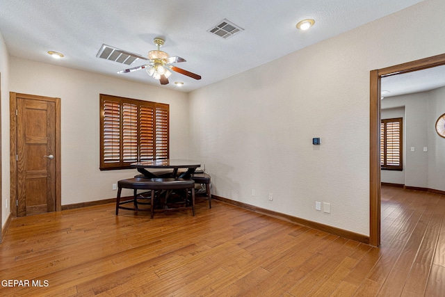 dining area featuring ceiling fan, a textured ceiling, and light wood-type flooring