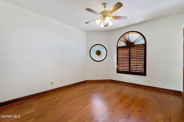 spare room featuring hardwood / wood-style flooring, ceiling fan, and a textured ceiling