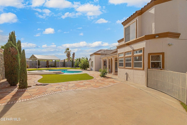 view of yard featuring a gazebo, a fenced in pool, and a patio area