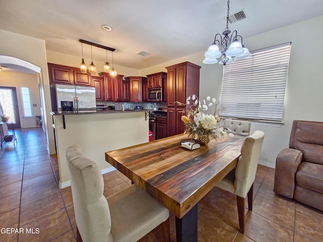 12298 Stansbury Dr, El Paso, TX 79928 - dining area featuring dark tile patterned flooring and a notable chandelier