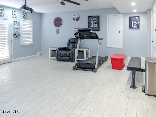 exercise area with ceiling fan and light hardwood / wood-style floors