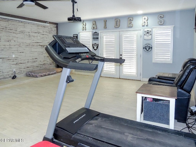 exercise area featuring french doors, hardwood / wood-style flooring, and ceiling fan