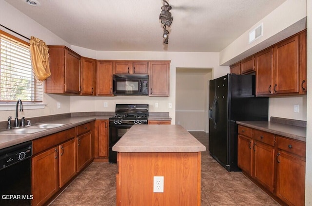 kitchen featuring sink, rail lighting, a kitchen island, and black appliances