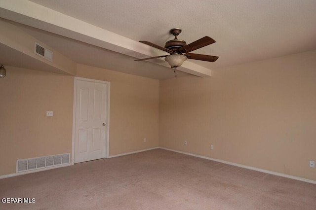 carpeted spare room featuring ceiling fan