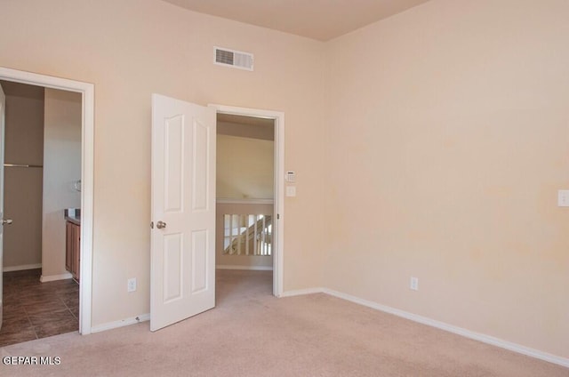 unfurnished bedroom featuring light carpet