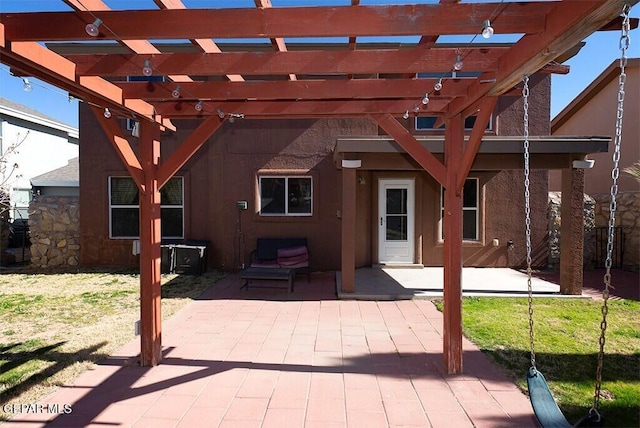 back of property featuring a pergola, a lawn, and a patio