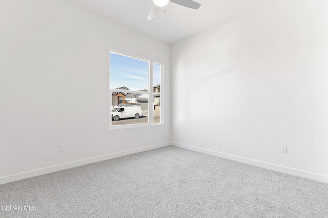 carpeted empty room featuring ceiling fan