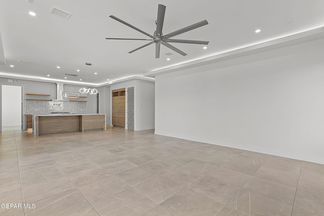 unfurnished living room with ceiling fan and light tile patterned flooring