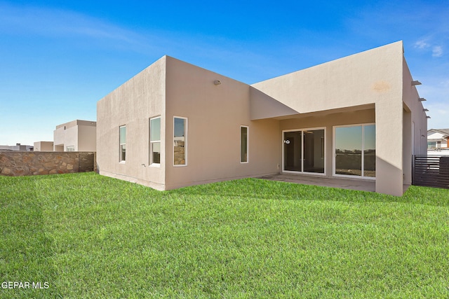 rear view of property featuring a yard