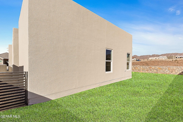 view of side of home featuring a lawn