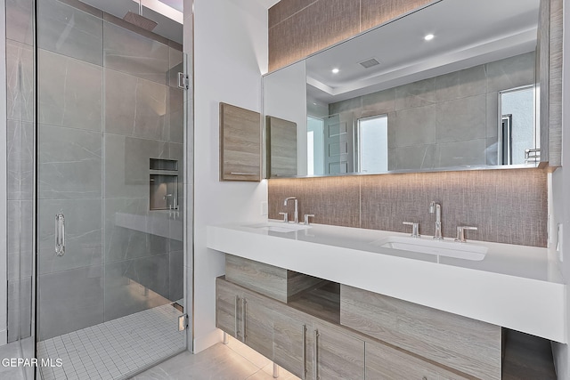 bathroom featuring tile patterned floors, a shower with door, and vanity