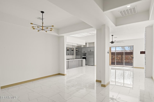 interior space featuring ceiling fan with notable chandelier