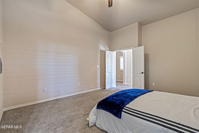 bedroom with ceiling fan, light colored carpet, and vaulted ceiling