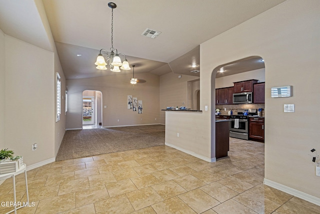 kitchen with vaulted ceiling, decorative backsplash, decorative light fixtures, stainless steel appliances, and a chandelier