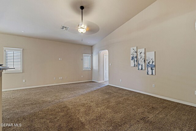 carpeted empty room with vaulted ceiling and ceiling fan