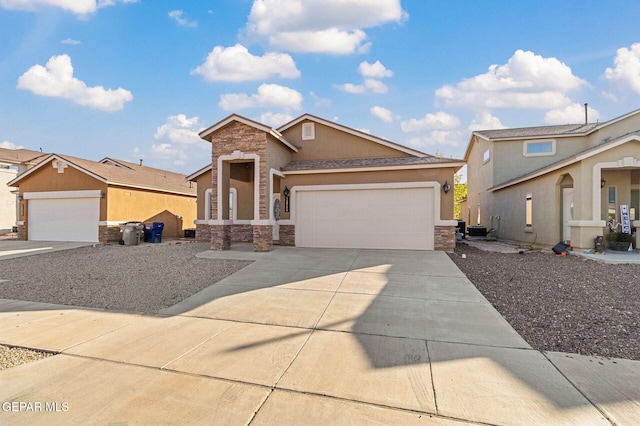 view of front of home featuring a garage and central air condition unit