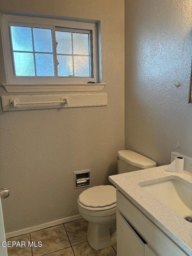 bathroom with tile patterned floors, vanity, and toilet