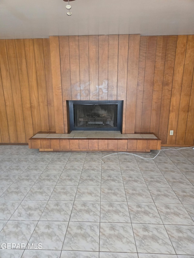 room details with wooden walls and a tile fireplace