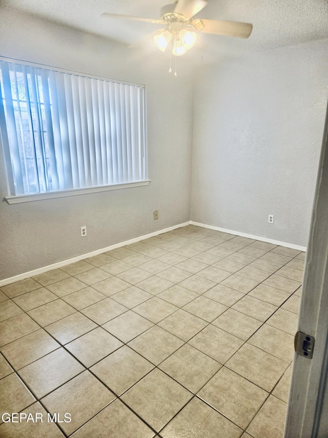 spare room featuring ceiling fan and a textured ceiling