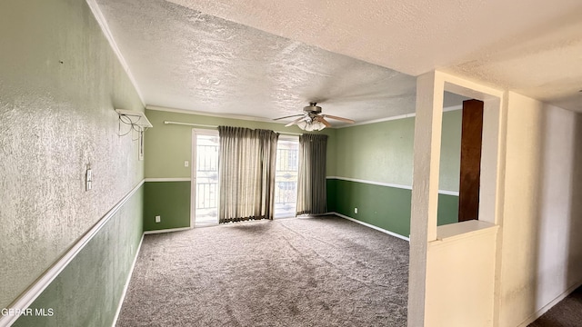 carpeted empty room featuring a textured ceiling and a ceiling fan