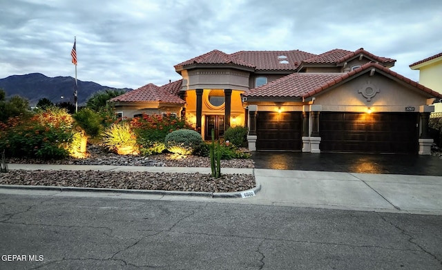 mediterranean / spanish home featuring a mountain view and a garage