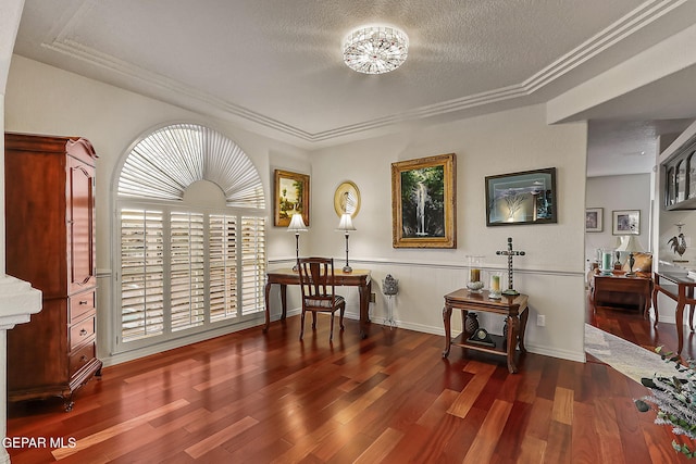 living area with a textured ceiling, dark hardwood / wood-style floors, and ornamental molding