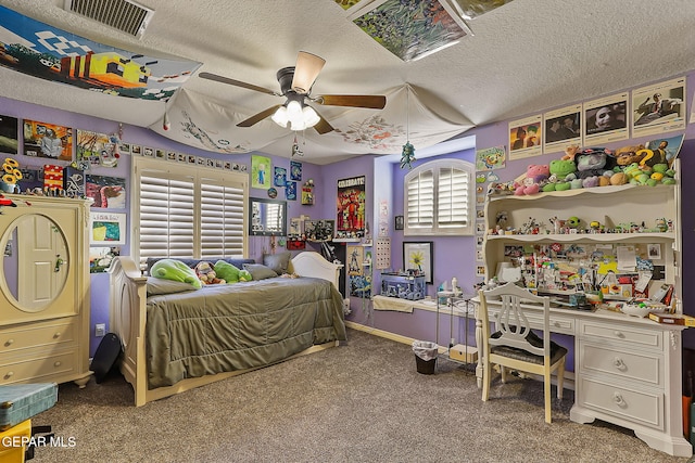 carpeted bedroom featuring a textured ceiling and ceiling fan