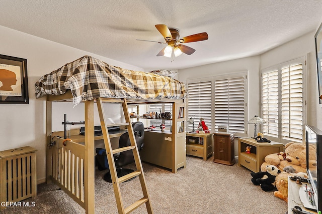 bedroom with light carpet, a textured ceiling, and ceiling fan