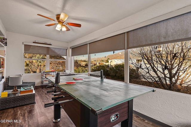 interior space with ceiling fan and a mountain view