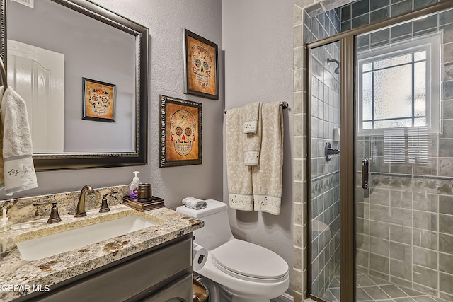 bathroom with vanity, toilet, and walk in shower