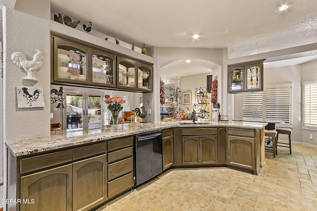 bar with dishwasher, dark brown cabinetry, light stone countertops, and sink