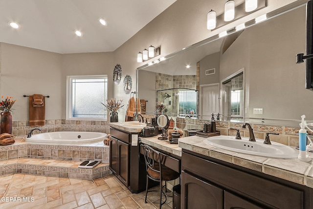 bathroom featuring vanity and separate shower and tub