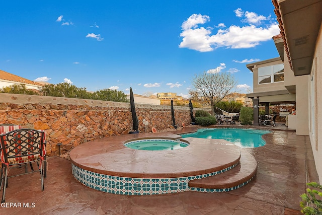 view of swimming pool with a patio area and an in ground hot tub