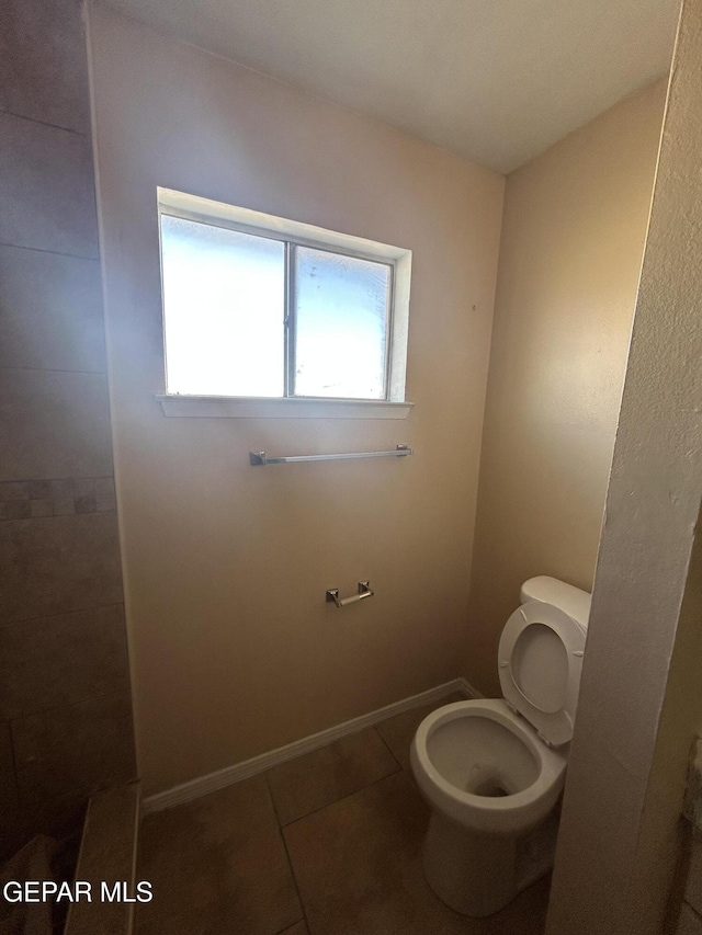 bathroom with tile patterned floors and toilet