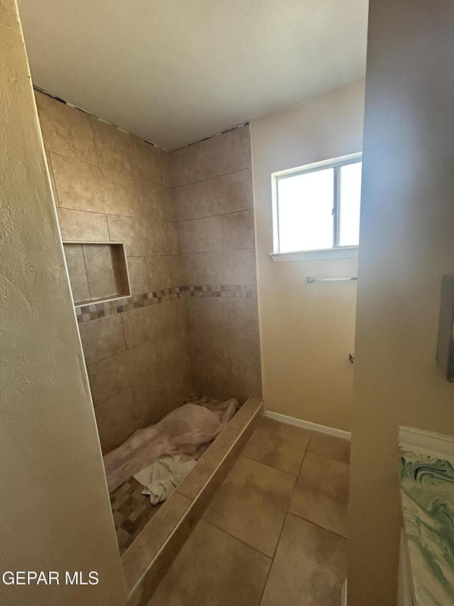 bathroom with tile patterned floors and a shower