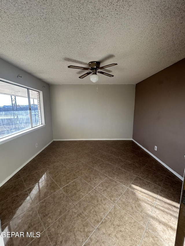 unfurnished room with tile patterned flooring, a textured ceiling, and ceiling fan