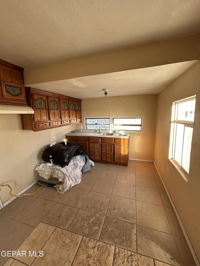 laundry room featuring light tile patterned floors and a textured ceiling