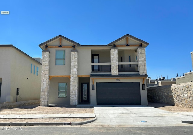 view of front of property featuring a balcony and a garage