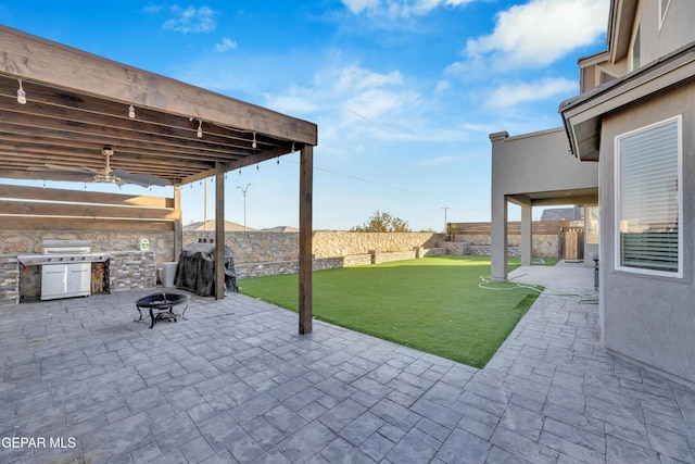 912 Crystal Deer Dr, El Paso, TX 79928 - fenced backyard with a patio area, an outdoor fire pit, and grilling area
