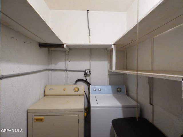 clothes washing area featuring washer and dryer