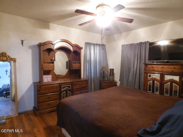 bedroom with hardwood / wood-style floors and ceiling fan