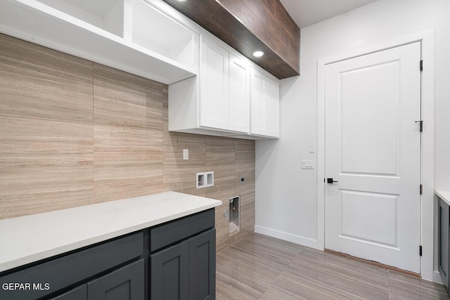 laundry area with hookup for an electric dryer, cabinets, and washer hookup