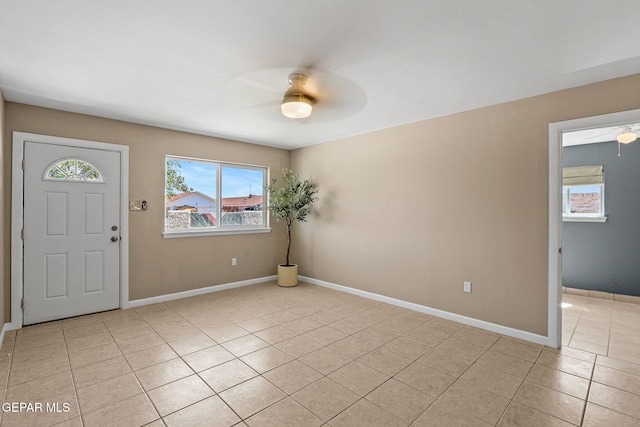 foyer with light tile patterned floors and ceiling fan