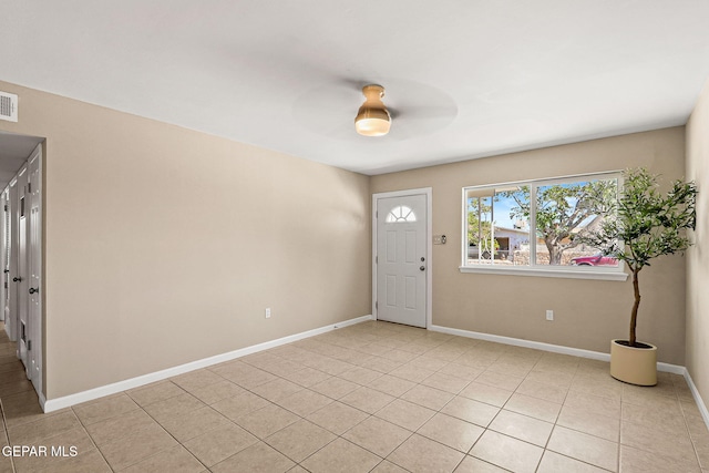 tiled foyer with ceiling fan