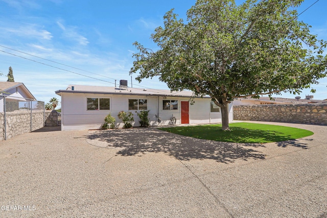 view of front of house featuring cooling unit and a front lawn