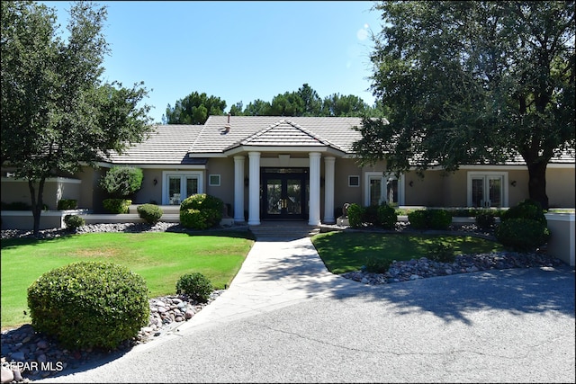 view of front of property with a front lawn and french doors