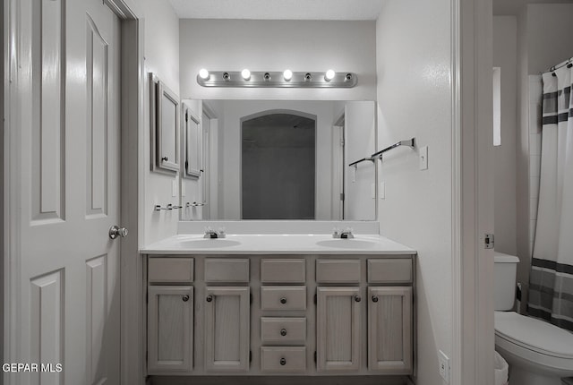 bathroom with vanity, toilet, and a shower with shower curtain