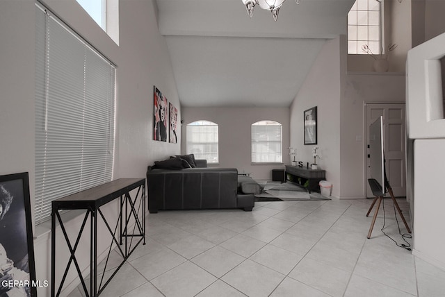 living room featuring high vaulted ceiling and light tile patterned flooring